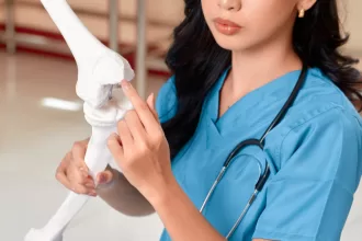 A female nurse holds a bone, symbolizing hope in bone marrow transplantation and patient care.