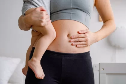 A woman cradles her newborn baby in her arms, showcasing the bond after a cesarean section delivery.
