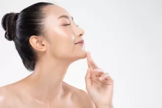 A woman with a smooth, clear complexion showcasing her chin augmentation, radiating confidence and beauty.