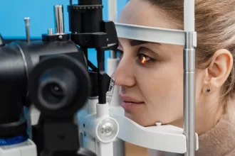 A woman undergoing an eye exam, focusing on her vision as part of a corneal transplant evaluation.