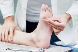 A person receiving a foot massage with a needle, highlighting diabetic foot surgery treatment techniques.