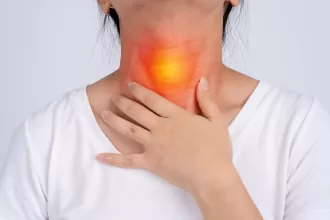 A woman with a sore throat and a red spot on her neck, reflecting her recovery from esophageal cancer surgery.
