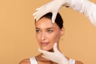 A woman undergoing face lift surgery, receiving treatment from a doctor in a clinical setting.