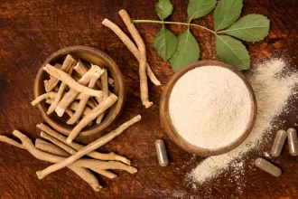 A collection of maca root powder recipes with smoothies, energy balls, and oatmeal on top of a wooden table.