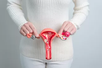 A woman holding a pink object, symbolizing hope and awareness for ovarian cystectomy and women's health.