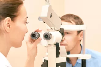 A woman undergoing an eye exam, focusing on retinal detachment repair, highlighting the importance of eye health.