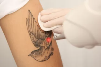 A person receiving a tattoo on their arm, highlighting the artistry and detail involved in the tattooing process.