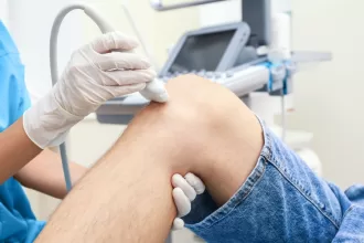 A patient receiving a knee injection, highlighting the importance of vascular surgery procedures like carotid endarterectomy.