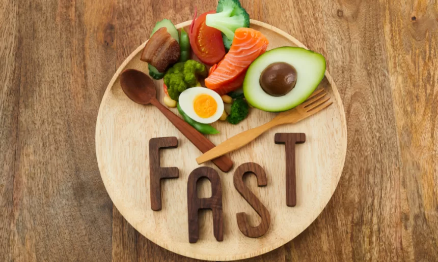 A healthy meal plate with colorful vegetables, lean protein, and a clock, symbolizing the concept of intermittent fasting for better health.